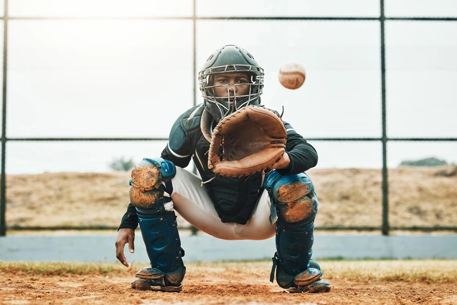 Baseball, catch and sports at the pitch for game, point or score with the ball on a field in the outdoors