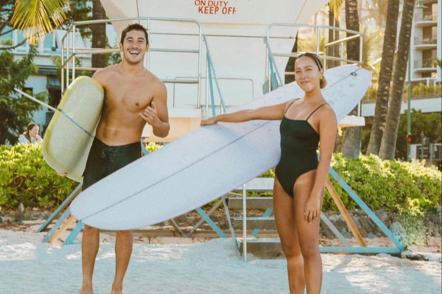 Couple Holding Surfboards