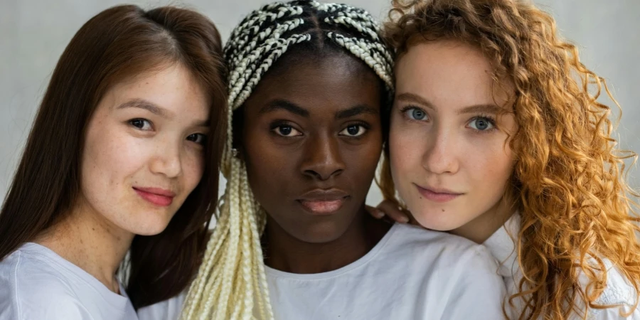 Diverse woman standing close and looking at camera