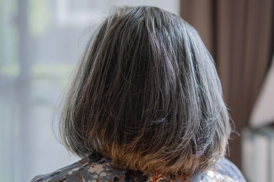 Elderly Asian woman with short grey natural colored vibrant silky hair