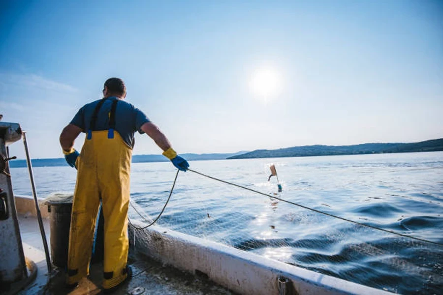 Homem com rede de pesca de malha quadrada no lago