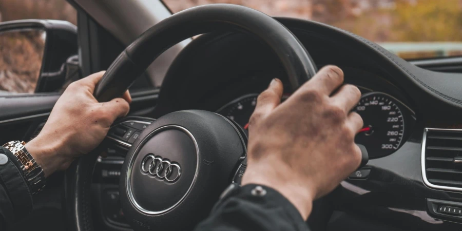 Mans Hands on a Steering Wheel