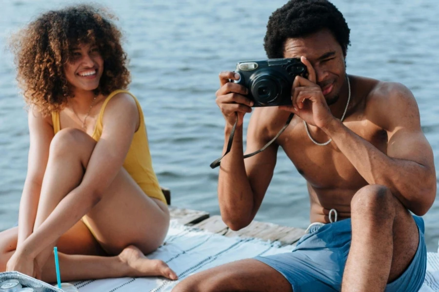 Portrait of Shirtless Man Taking Photo at Lake