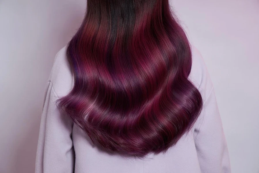 Portrait of a woman with bright colored flying hair, all shades of purple