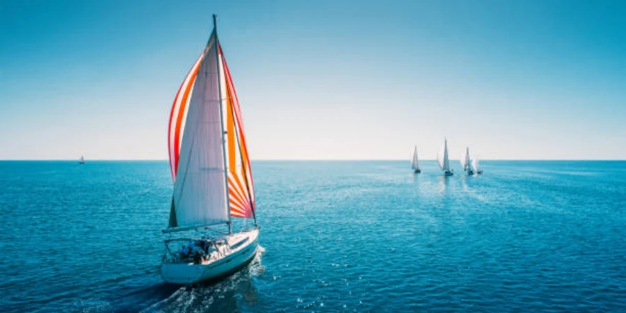 Yacht a vela da regata con vele bianche in mare aperto