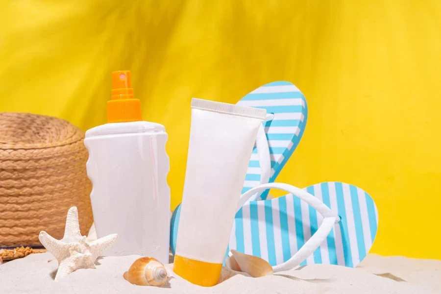 Sunscreen bottle on sand background