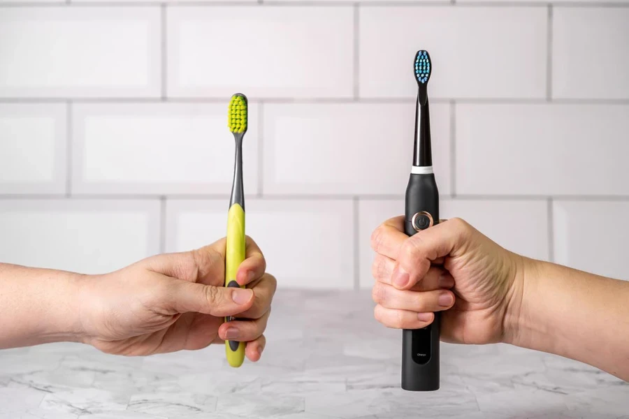 Two Electric Toothbrushes in Hands