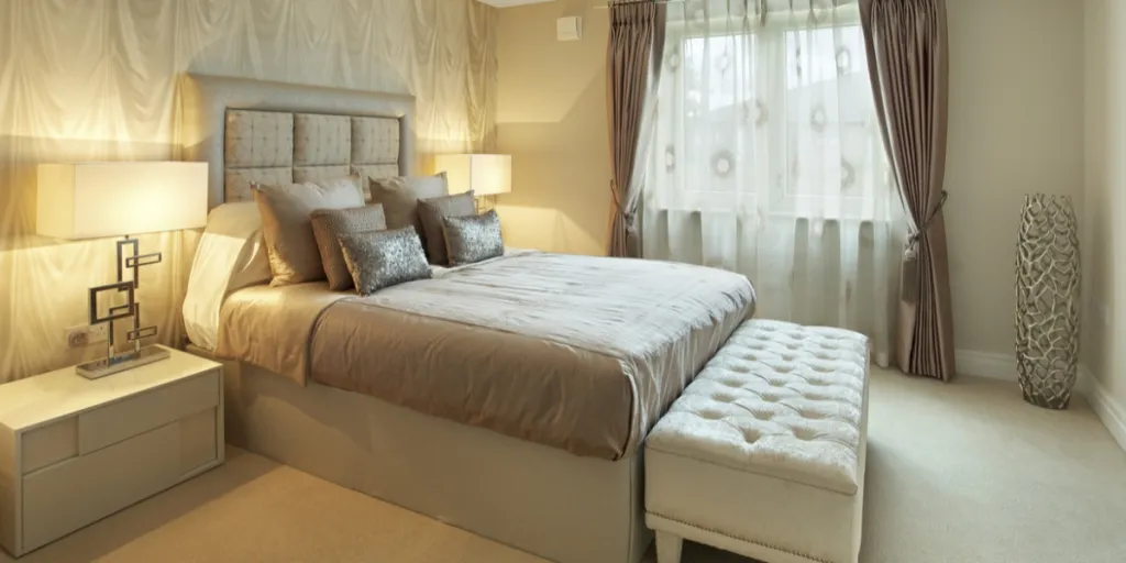 Warm bedroom with tufted ottoman