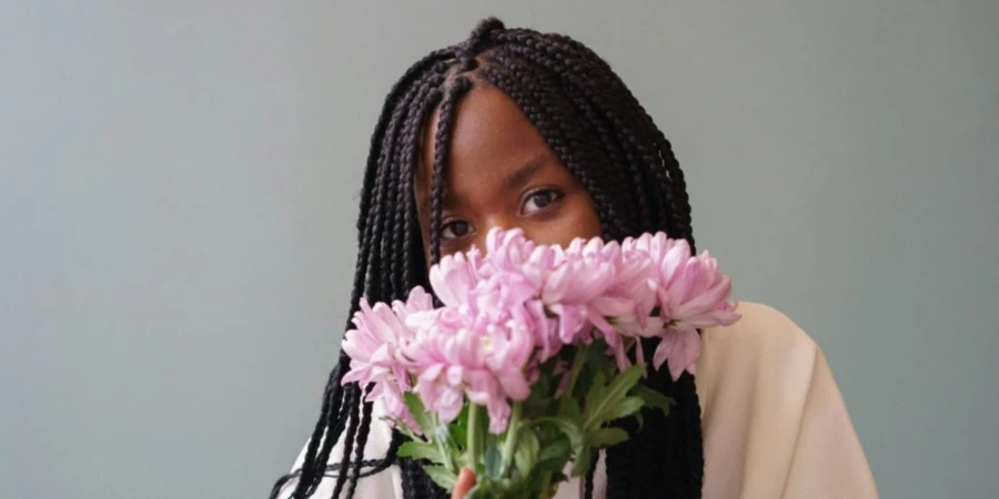 Woman Holding Flowers in Coi Leray Braids