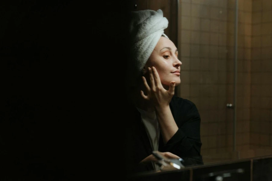 Woman in White Hijab Covering Her Face With White Towel