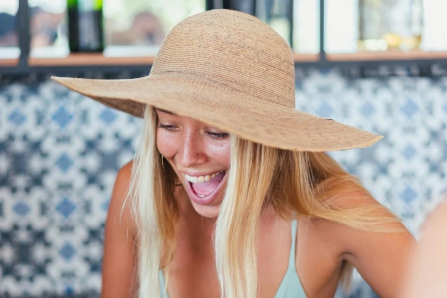 Woman wearing a straw hat with a wide brim