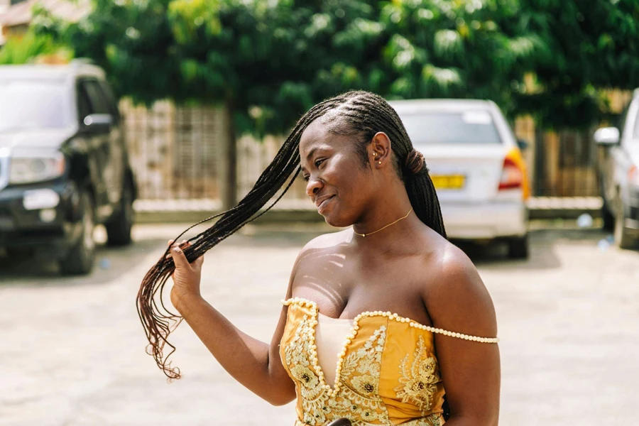 Woman with Coi Leray Braids Smiling