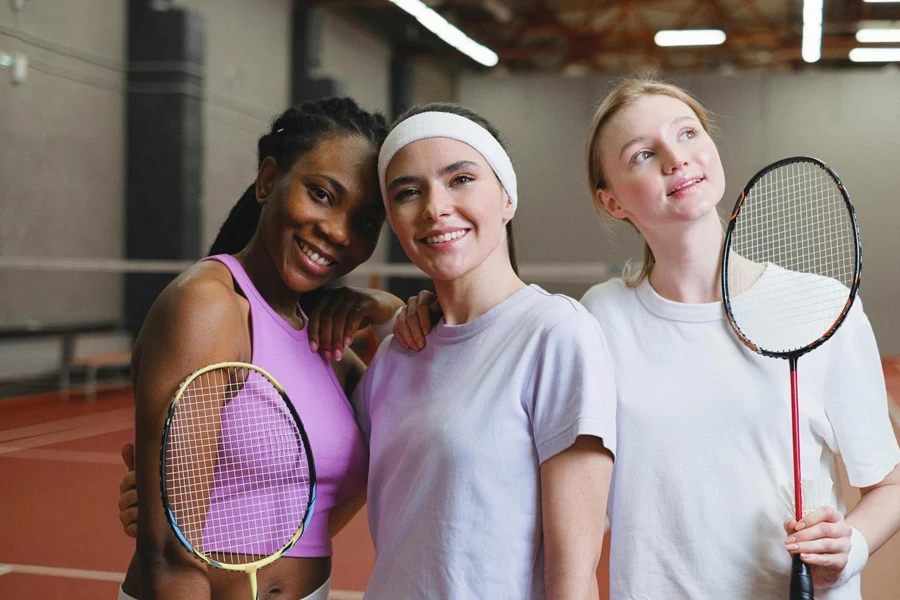 Women Holding Badminton Rackets