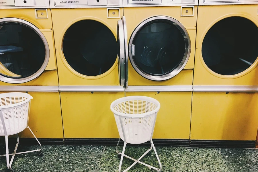 Yellow washing machine and white laundry basket