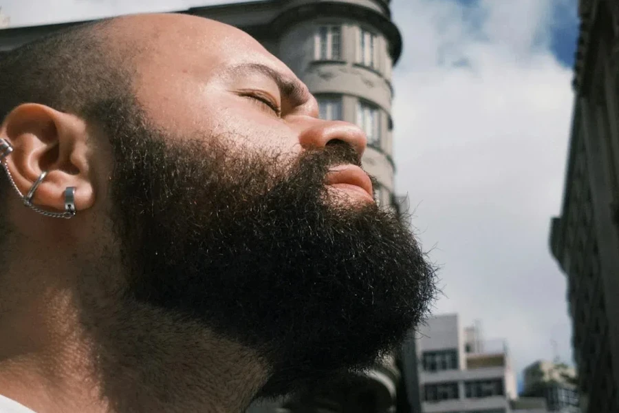 Bearded man wearing silver ear cuffs