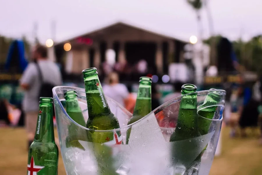 Clear plastic ice bucket with bottles of beer inside