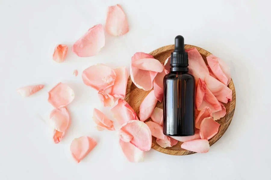 cosmetic bottle with pink rose petals