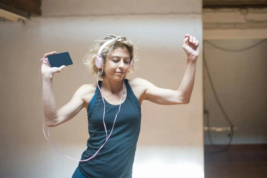 Lady dancing while listening to music on her headphones