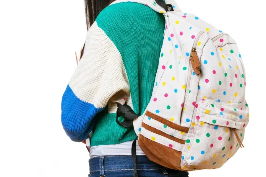 Teenage girl carrying a polka dot backpack