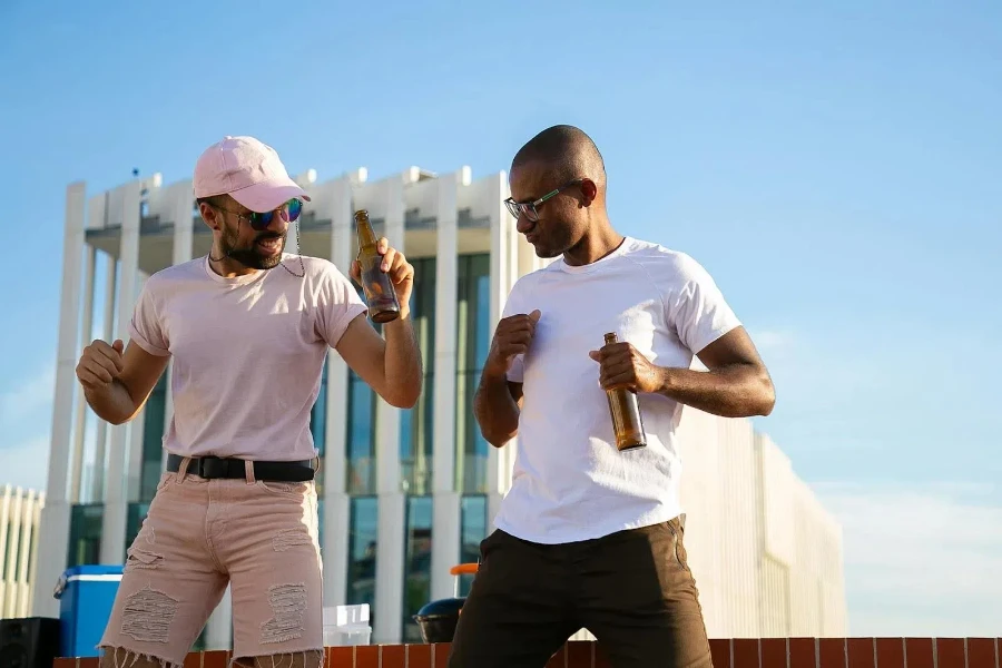 Two happy young men dancing outdoors