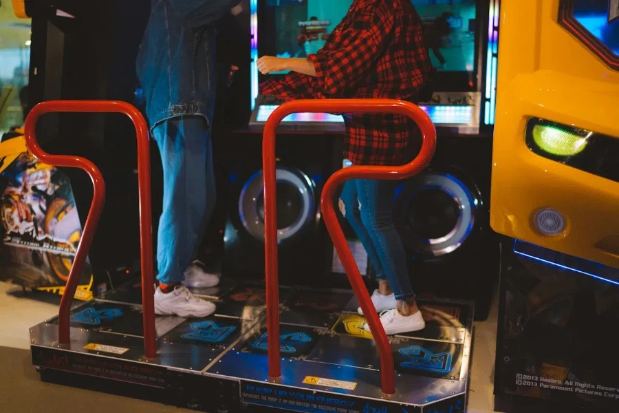 Two people on a dance arcade machine