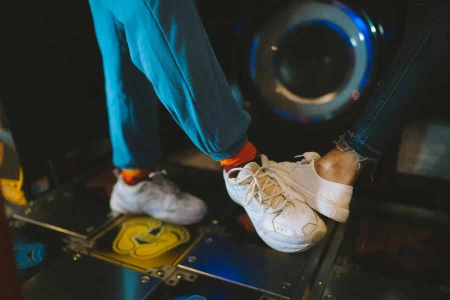 Two people playing a game on a dance pad