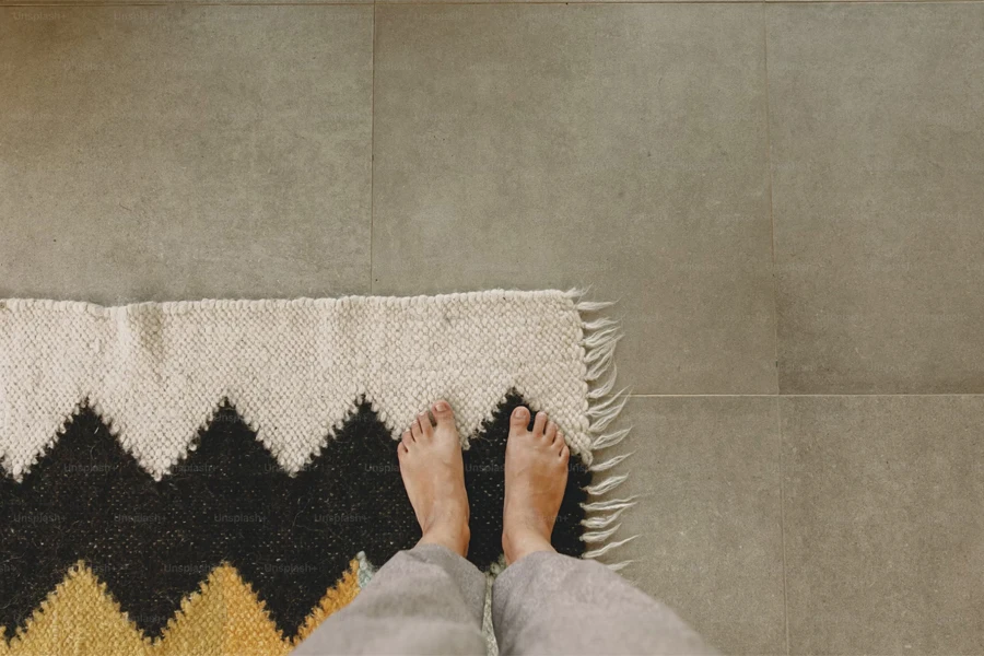 woman barefoot standing on modern rug in comfortable stylish home