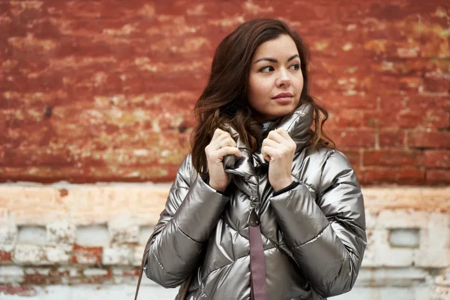 Woman holding the collar of a leather quilted jacket