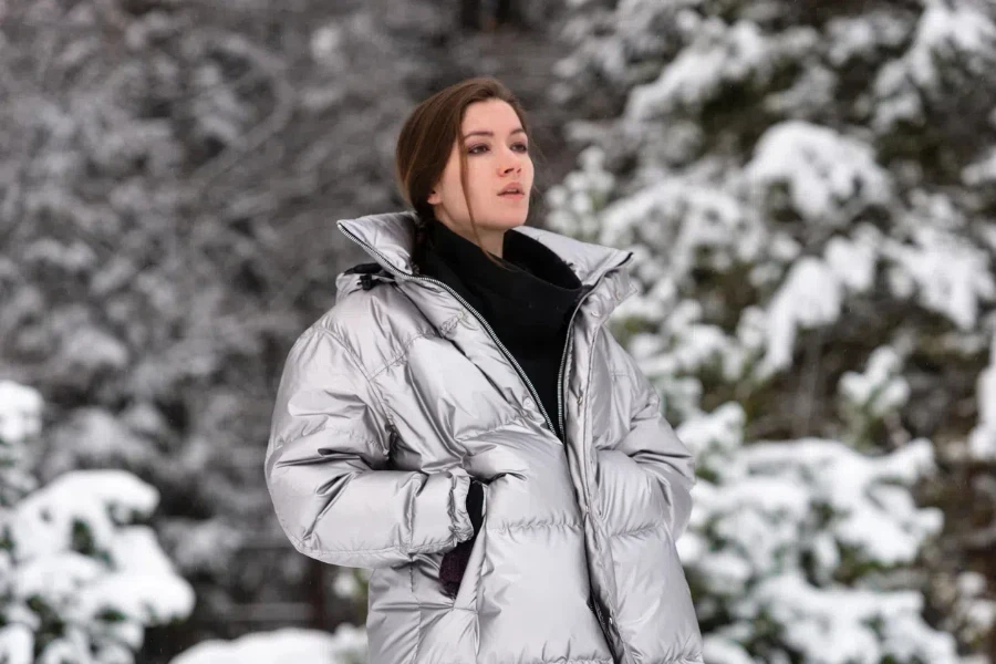 Woman posing in silver oversized quilted jacket