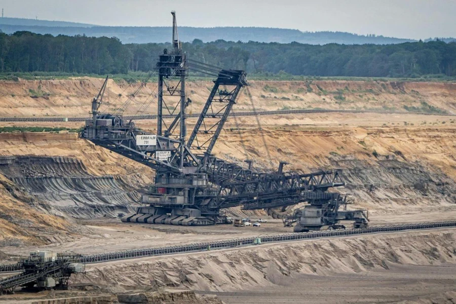 A bucket wheel excavator working with a conveyor belt to efficiently remove material from the dig site