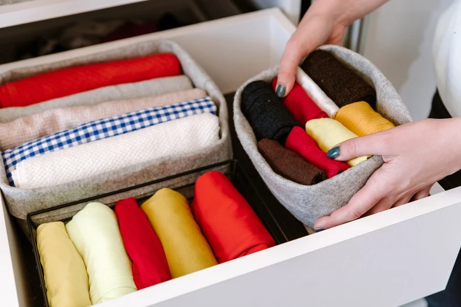 Person arranging clothes in an organizer