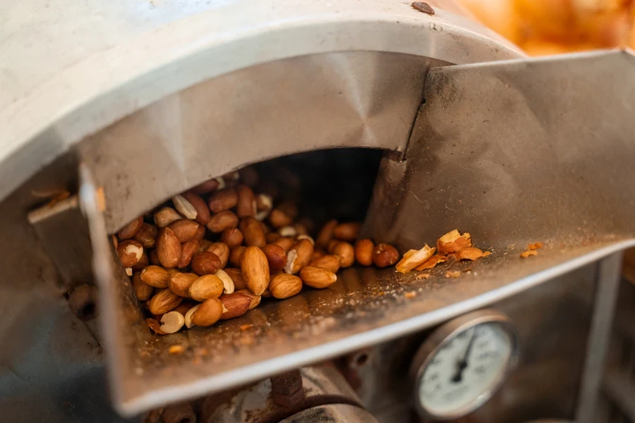 Roasting and blanching peanuts. Process of peeling peanuts in machine