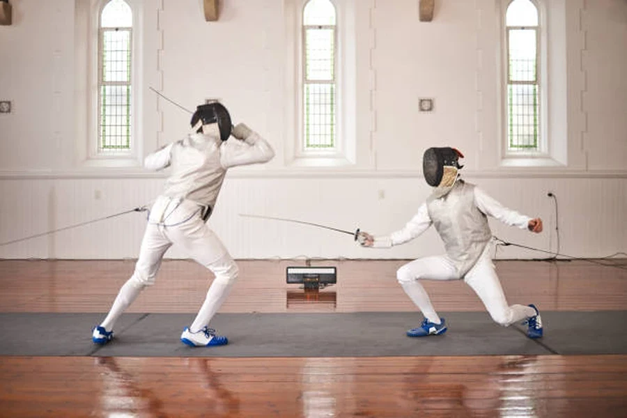 Two female fencers training with fencing shoes and rapier