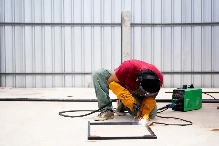 Man using an adjustable welder on steel