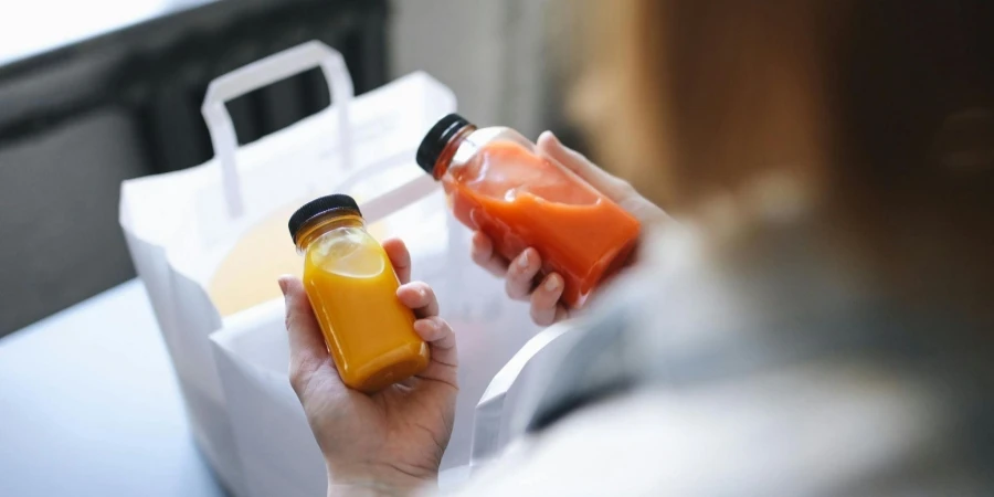 A Person Holding Bottles of Juices