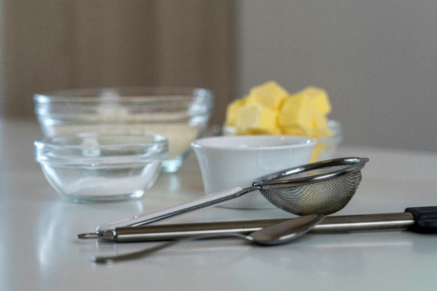 A close-up of a spoon and a bowl of butter