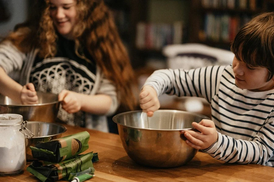 A couple of kids mixing food