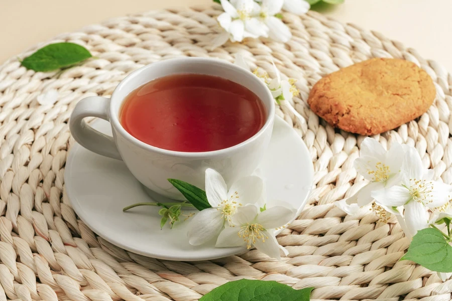 A cup of jasmine tea on a wicker placemat