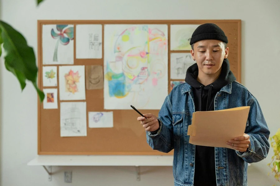 A person holding a pen and a folder