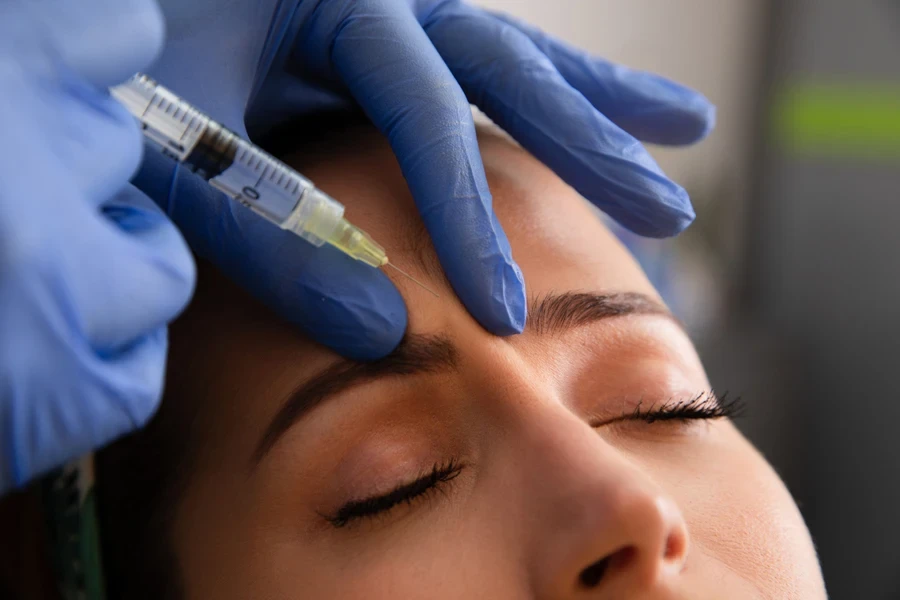 A woman receiving botox treatment on her face