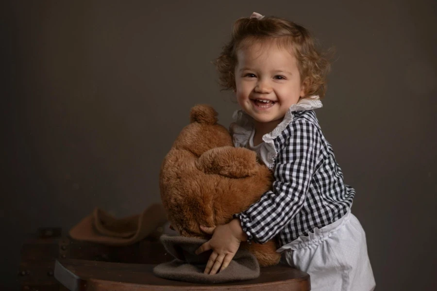 Adorable Child Hugging Teddy Bear with Joy