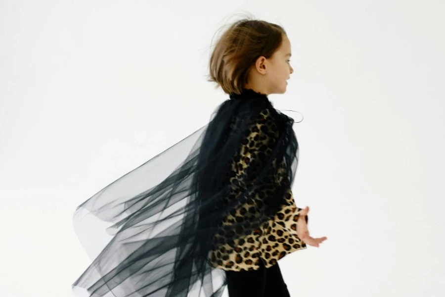 Girl Wearing a Leopard Print Long Sleeve Shirt with Black Organza Cloak