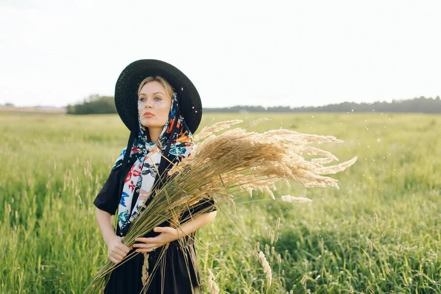 Femme portant un foulard pour les cheveux associé à un chapeau noir