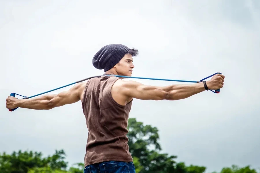 Fit young man in a pulled-back beanie exercising outdoors