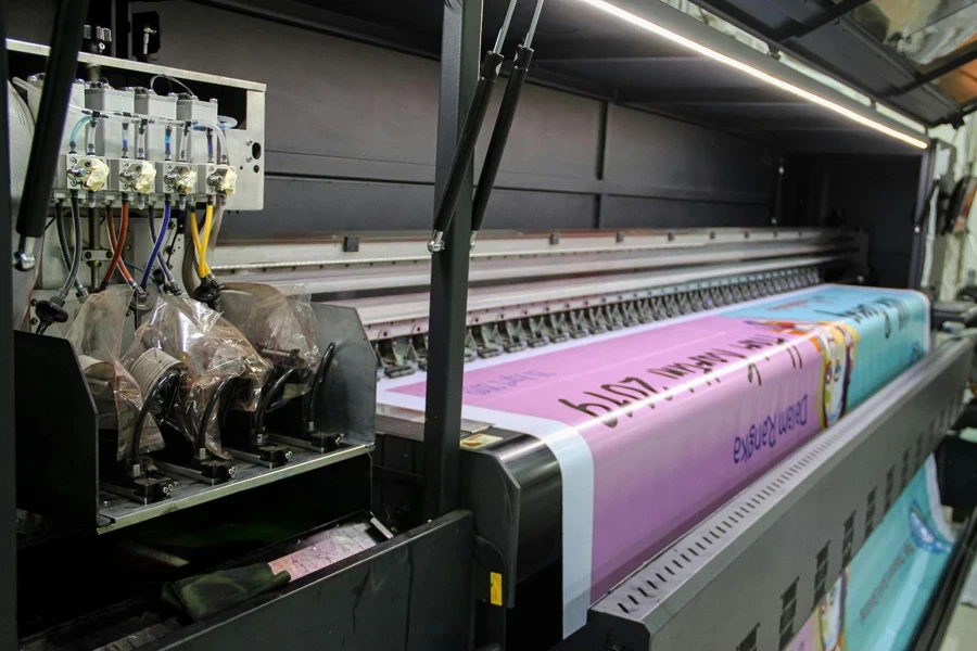 A large printer with a pink banner