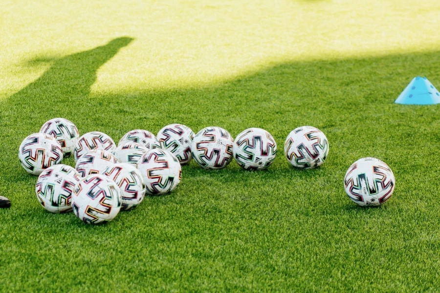 Close-Up Shot of Soccer Balls on Soccer Field