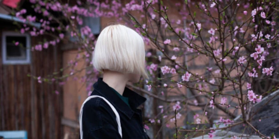 Healthy young woman in spring against blossom tree flowers