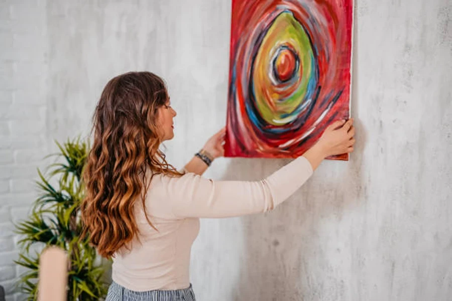 Woman Hanging Her Art on the Wall