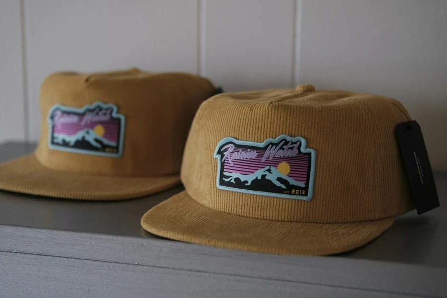 Yellow corduroy baseball caps with logos