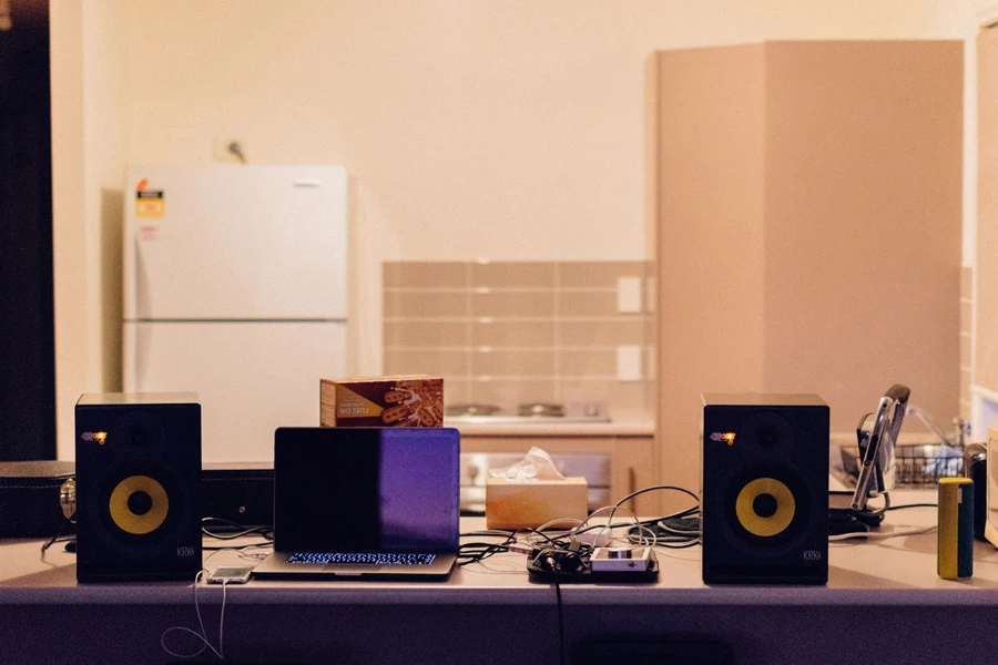 a table with speakers and a laptop on it